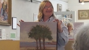 Amy Gernhardt showing off Susan Dauphinee's painting